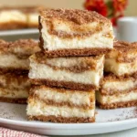 Snickerdoodle cheesecake bars with cinnamon sugar cookie topping