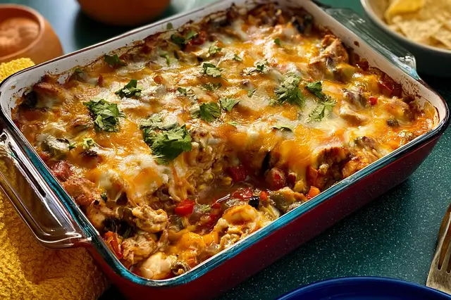 Chicken fajita casserole with seasoned chicken, bell peppers, onions, and melted cheese