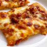 School Pizza: A Nostalgic Slice of American Cafeteria Lunches 5 School pizza with soft crust, tomato sauce, and melted mozzarella cheese