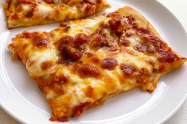 School Pizza: A Nostalgic Slice of American Cafeteria Lunches 3 School pizza with soft crust, tomato sauce, and melted mozzarella cheese