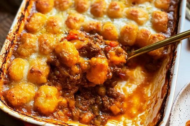 Sloppy Joe tater tot casserole with ground beef, cheese, and crispy tots