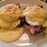 Benedict Arnold Eggs: A Historical Twist on Classic Eggs Benedict 5 Benedict Arnold eggs with poached eggs, hollandaise, and savory toppings