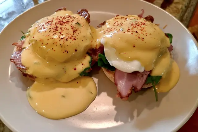 Benedict Arnold Eggs: A Historical Twist on Classic Eggs Benedict 3 Benedict Arnold eggs with poached eggs, hollandaise, and savory toppings