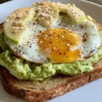 Avocado toast with egg and thinly sliced apple