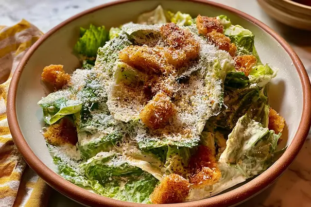 Twists on Caesar Salad: Creative Ways to Elevate the Classic Dish 3 Fresh Caesar salad with crisp romaine lettuce, crunchy croutons, and shredded Parmesan cheese.
