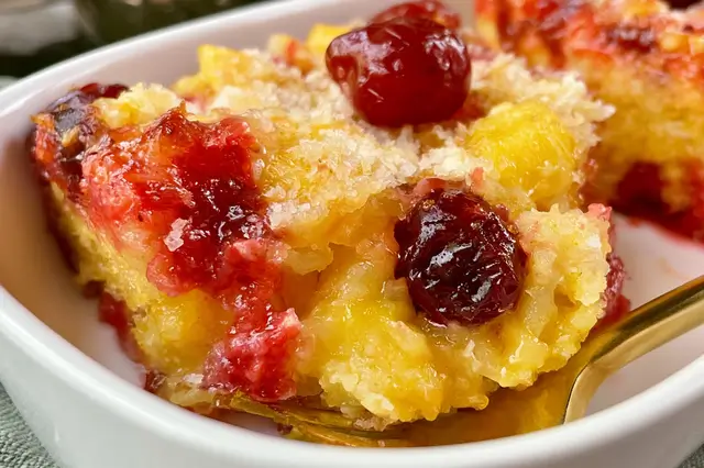 Pineapple Dump Cake with Cherries – Easy Dessert Recipe 3 Pineapple dump cake with cherries topped with golden cake crust in a baking dish.