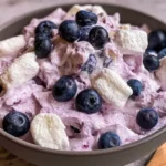 Fluffy blueberry marshmallow delight with fresh blueberries, whipped cream, and mini marshmallows