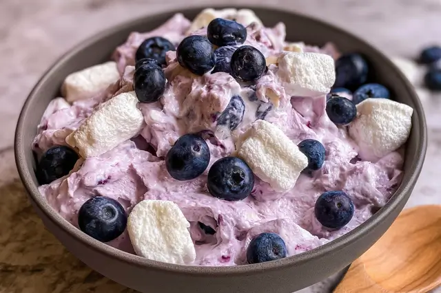 Fluffy blueberry marshmallow delight with fresh blueberries, whipped cream, and mini marshmallows
