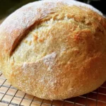 Bread in 20 Minutes – Quick and Easy Recipe for Busy Lives 5 Freshly baked quick bread loaf sliced warm on a wooden cutting board.