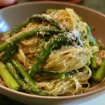 Fresh green asparagus and pasta tossed with garlic, olive oil, lemon, and parmesan cheese.