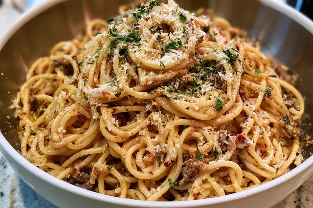 Garlic parmesan beef and spaghetti pasta tossed with garlic, ground beef, and grated cheese.