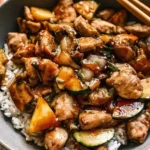 Sautéed bite-sized hibachi chicken coated in soy teriyaki sauce in a skillet.