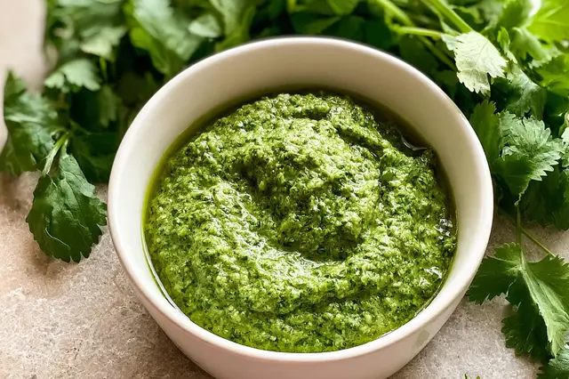 Fresh homemade cilantro pesto with blanched almonds, red onion, and extra virgin olive oil