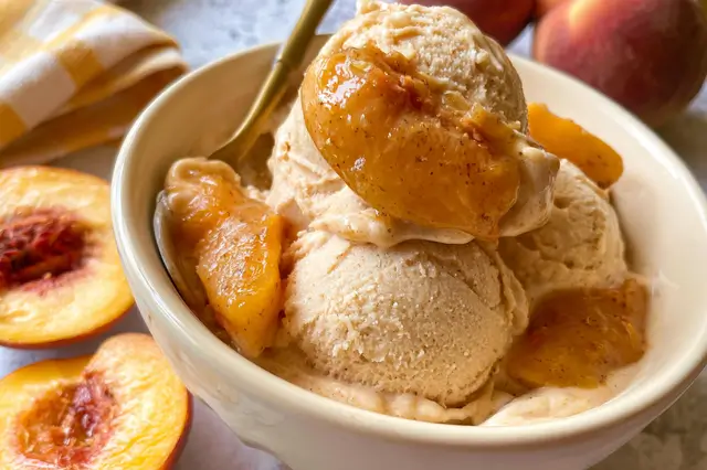Creamy homemade peach ice cream churned with fresh ripe peaches, heavy cream, and vanilla.