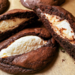 Fudgy chocolate brownie cookies topped with a dollop of cream cheese filling and chocolate chips.