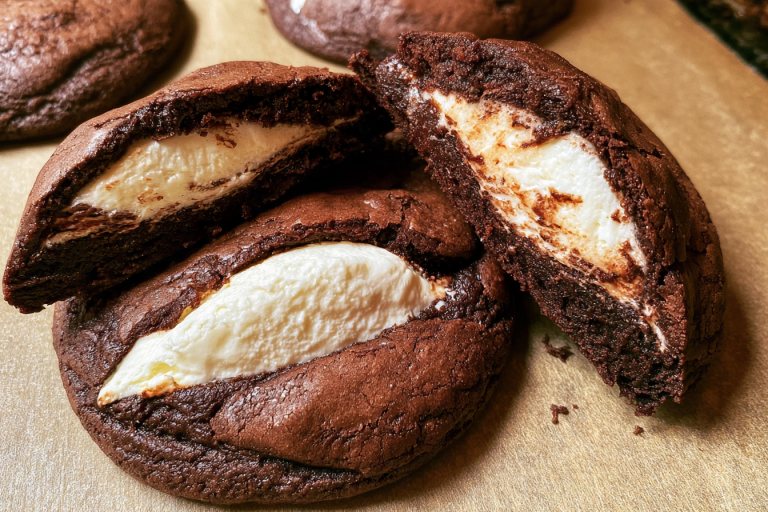 Fudgy chocolate brownie cookies topped with a dollop of cream cheese filling and chocolate chips.