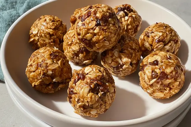 Healthy no-bake granola energy bites rolled with oats, peanut butter, and chocolate chips.