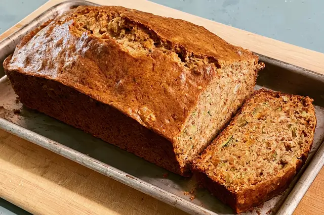 Freshly baked Mom's zucchini bread loaf made with shredded zucchini, cinnamon, and chopped walnuts.