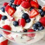 RED WHITE AND BLUE CHEESECAKE SALAD: A Festive Delight 5 Red white and blue cheesecake salad with fresh strawberries, blueberries, and mini marshmallows.