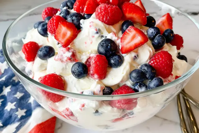 RED WHITE AND BLUE CHEESECAKE SALAD: A Festive Delight 3 Red white and blue cheesecake salad with fresh strawberries, blueberries, and mini marshmallows.