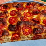 Fresh Double-Tomato Focaccia topped with cherry tomatoes, shallot rings, tomato sauce, and basil