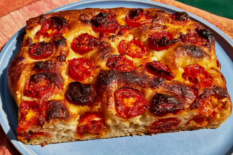 Fresh Double-Tomato Focaccia topped with cherry tomatoes, shallot rings, tomato sauce, and basil