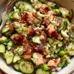 Crispy Rice Salmon Cucumber Salad with Creamy Asian Dressing 5 Crispy rice salmon cucumber salad with flaked salmon, avocado, edamame, and creamy Asian dressing.