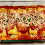 Manicotti: A Delicious Twist on Classic Italian Comfort 5 Baked manicotti shells stuffed with ricotta and mozzarella cheese in marinara sauce.