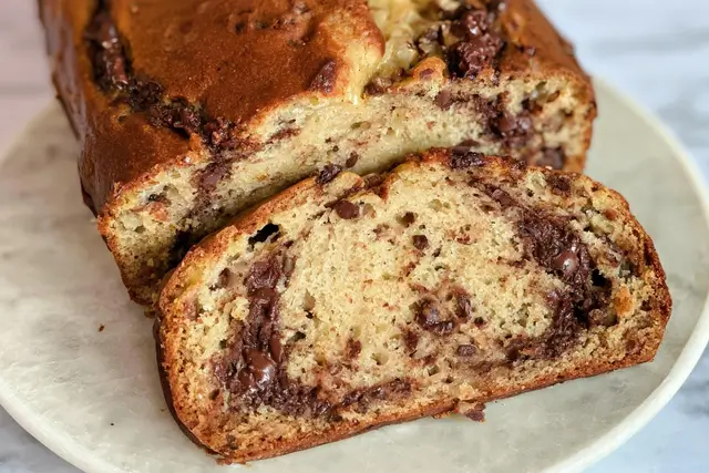 Moist banana bread loaf with rich chocolate hazelnut Nutella swirls throughout the batter.