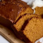 Moist slice of gluten-free pumpkin bread spiced with cinnamon, nutmeg, and cloves.