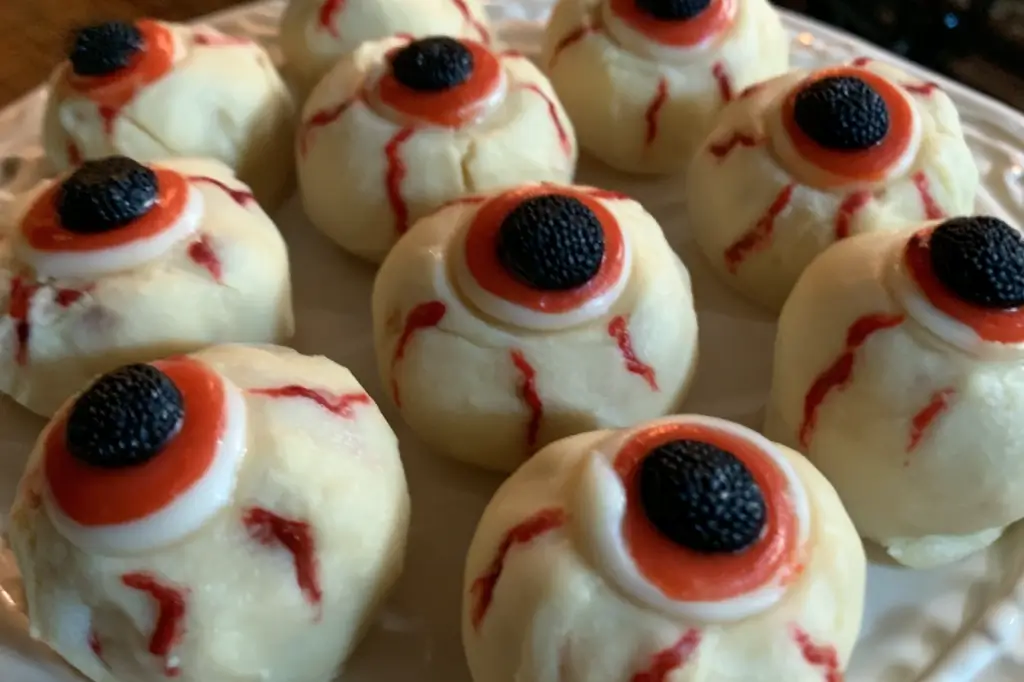 No-bake spooky Halloween eyeballs made with peanut butter, white chocolate, and blue chocolate pupils.