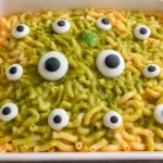 Vibrant green Halloween monster mac and cheese made with white cheddar, fontina, and noodles.