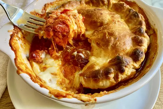 Pizza pot pie with sausage, peppers, onions, mushrooms, sauce, and golden crescent dough