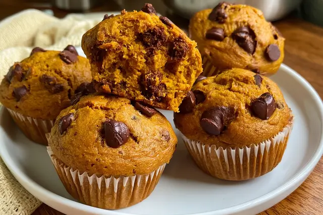 Freshly baked pumpkin chocolate chip muffins filled with cozy fall spices and semisweet chocolate chips.