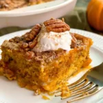 Baked pumpkin dump cake with spice cake mix, melted butter, and chopped pecans.