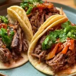 Slow-cooked Korean beef shredded and served in warm corn tortillas with fresh toppings.