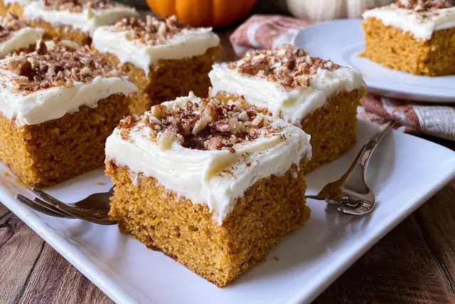 Moist spiced pumpkin bars topped with a thick layer of creamy cream cheese frosting.