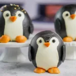 Delicious Penguin Cupcakes Displayed on a Cake Stand