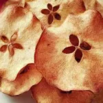 Homemade Apple Chips on a Wooden Board