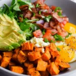 Sweet Potato Breakfast Bowl Garnished with Avocado and Nuts