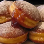Freshly Made Jelly Doughnuts Stacked on a Plate