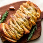 Rosemary Garlic Pull Apart Bread on a Wooden Board