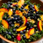 Summer Peach Blueberry Kale Salad on a Rustic Table