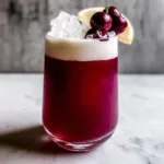 Tropical Cherry Rum Cocktail Garnished with Fresh Cherries
