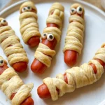 Halloween Mummy Hotdogs on a spooky plate