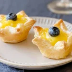 Lemon Curd Puff Pastry Cups That Will Delight You 5 Lemon Curd Puff Pastry Cups on a Serving Plate